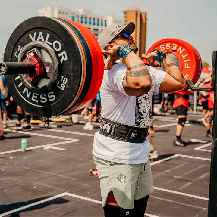 Athlete mid-front rack lift at outdoor competition wearing Surf Green FLX Pro Short.
