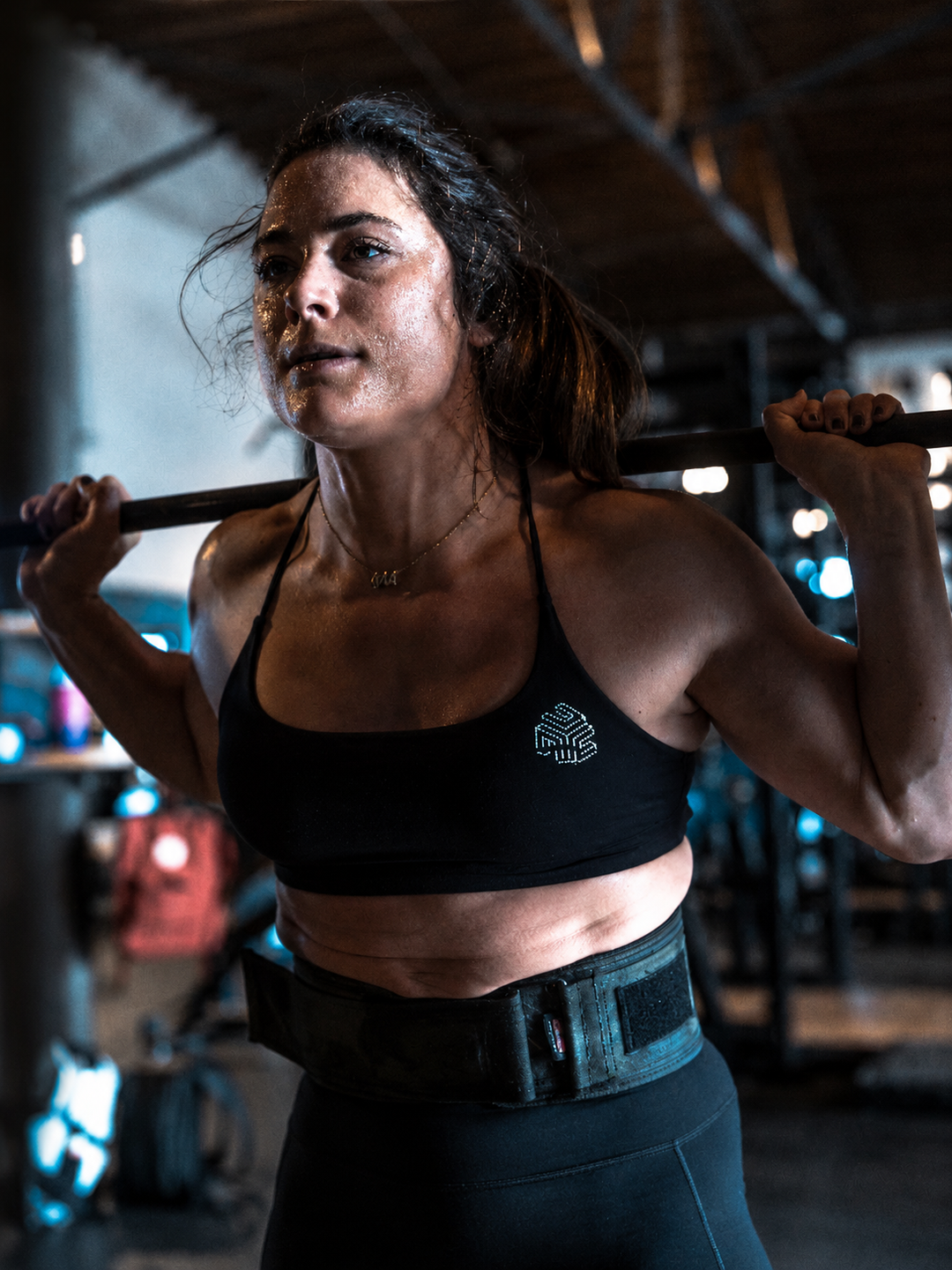 Woman lifting a barbell in a gym setting