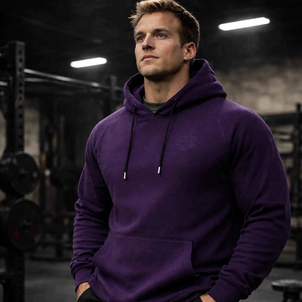 Man wearing a purple hoodie in a gym setting
